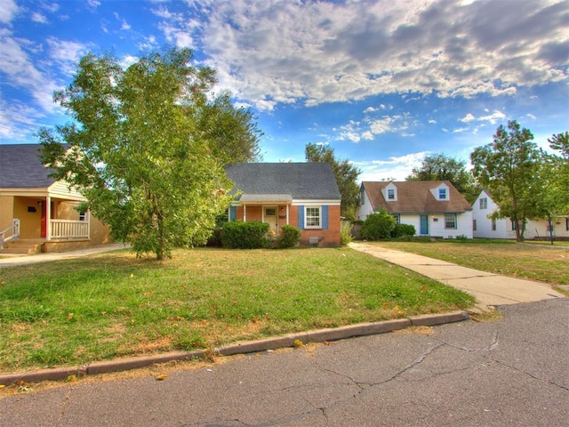 view of front of house featuring covered porch and a front yard