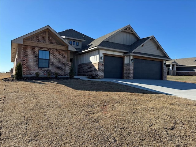 view of front of home featuring an attached garage, driveway, board and batten siding, and brick siding