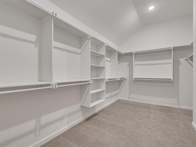 walk in closet featuring vaulted ceiling and carpet floors