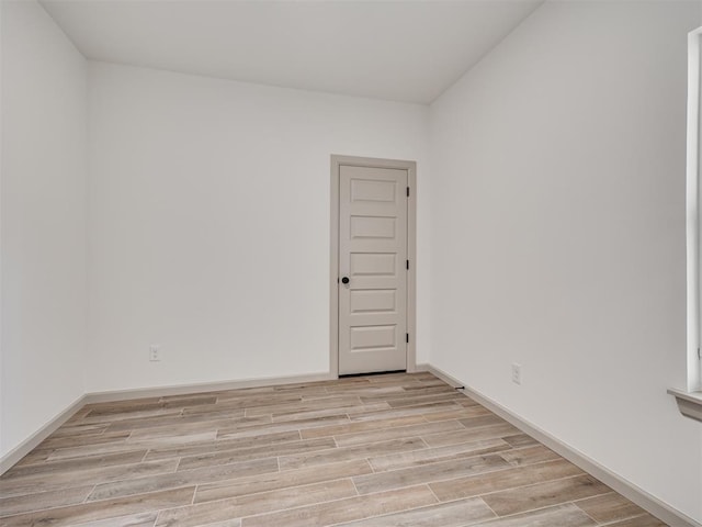 unfurnished room featuring wood finish floors and baseboards