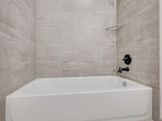 bathroom with a tub to relax in and a shower