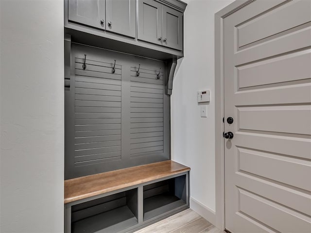 mudroom with light wood-style flooring and baseboards