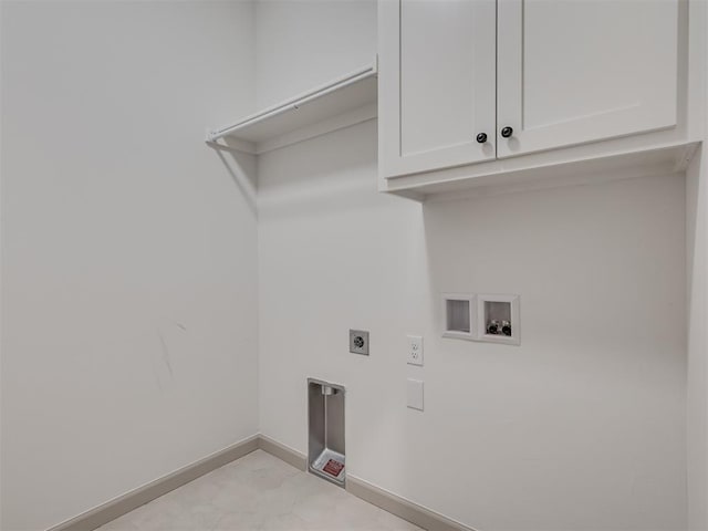 laundry area featuring cabinet space, hookup for a washing machine, baseboards, and hookup for an electric dryer