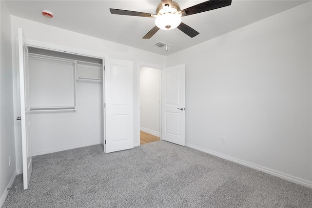 unfurnished bedroom with a closet, carpet flooring, baseboards, and visible vents