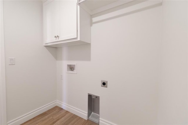 washroom with baseboards, washer hookup, light wood-type flooring, hookup for an electric dryer, and cabinet space