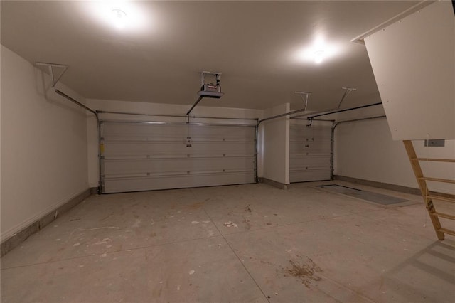 garage featuring a garage door opener and baseboards