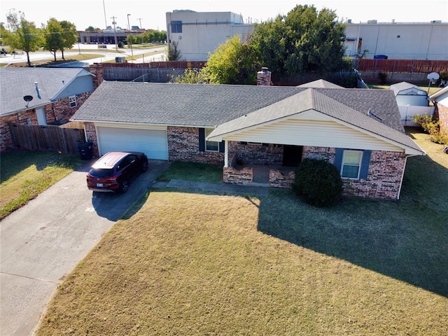 ranch-style home featuring a garage and a front lawn