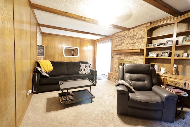 living room featuring a brick fireplace, a textured ceiling, wooden walls, beamed ceiling, and carpet floors