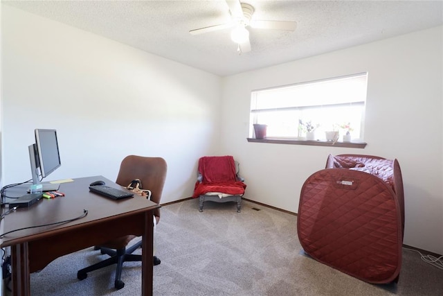 office area with ceiling fan, light colored carpet, and a textured ceiling