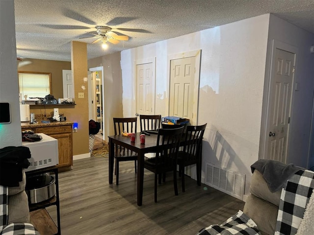 dining room featuring hardwood / wood-style floors, a textured ceiling, and ceiling fan