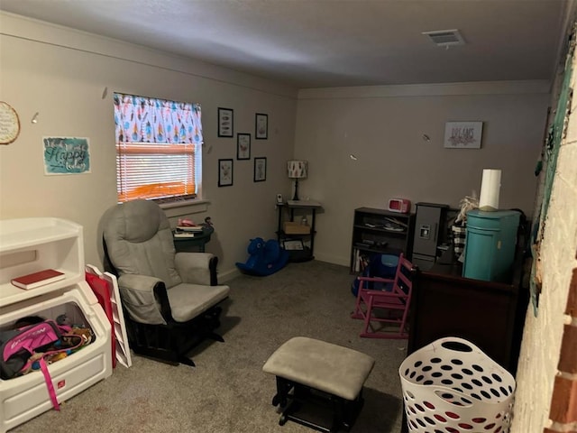 sitting room featuring carpet floors and ornamental molding