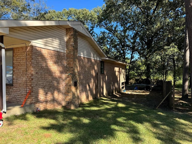 view of home's exterior with a yard