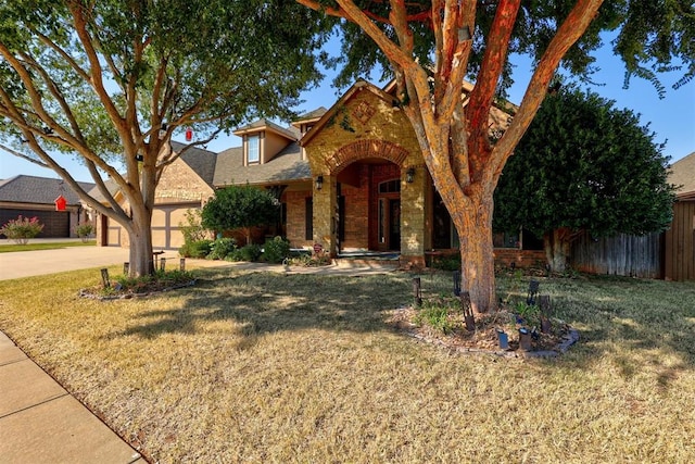 view of front of property featuring a garage and a front yard