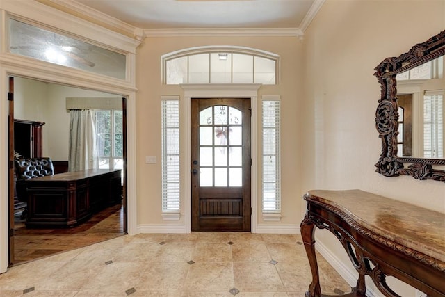 entrance foyer featuring plenty of natural light, light wood-type flooring, and ornamental molding