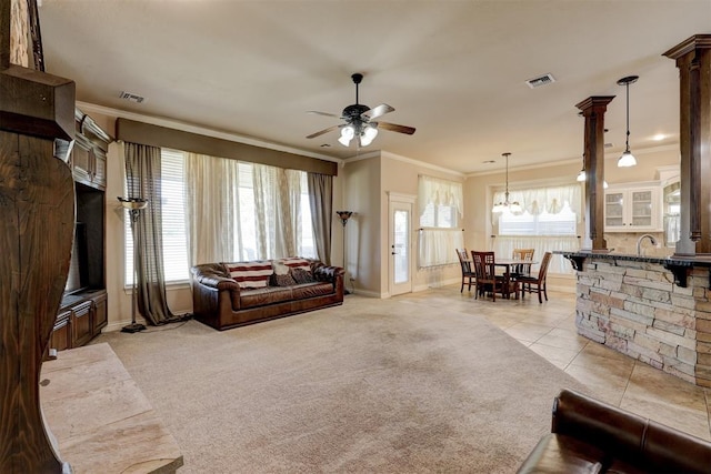 carpeted living room featuring ceiling fan, ornamental molding, and sink