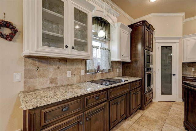 kitchen featuring decorative backsplash, ornamental molding, light tile patterned floors, appliances with stainless steel finishes, and light stone counters