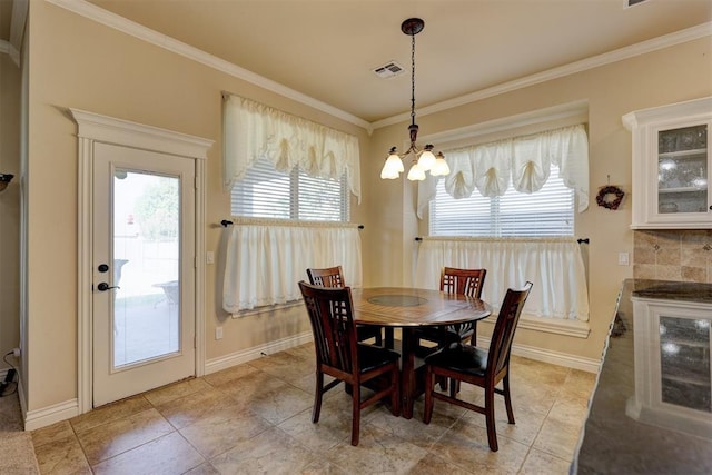 dining space featuring light tile patterned floors, an inviting chandelier, and ornamental molding