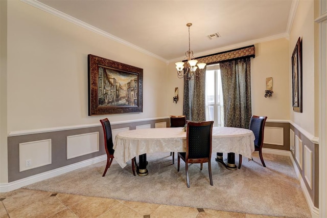 dining area featuring crown molding, carpet, and a chandelier