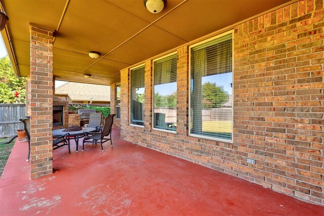 view of patio / terrace with an outdoor brick fireplace