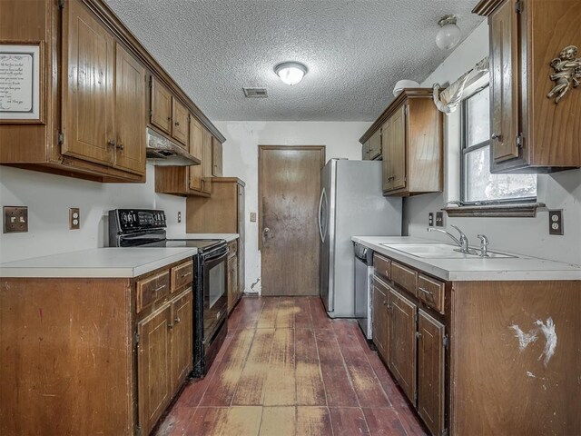 kitchen featuring dishwasher, sink, electric range, a textured ceiling, and dark hardwood / wood-style flooring