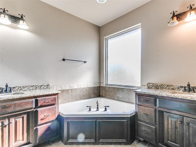 bathroom featuring vanity and a tub to relax in