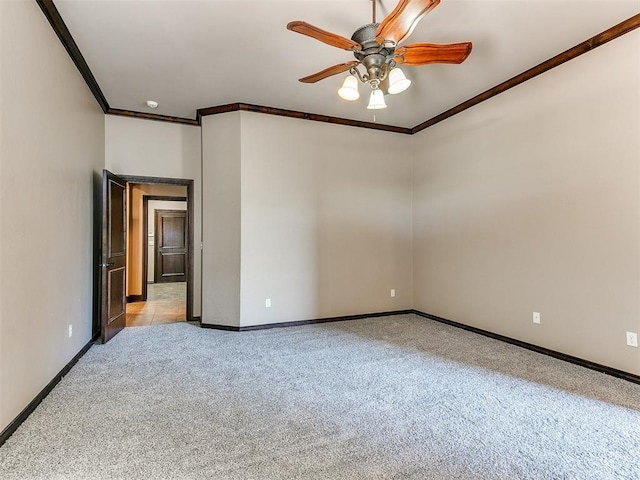 unfurnished room featuring ceiling fan, light colored carpet, and ornamental molding