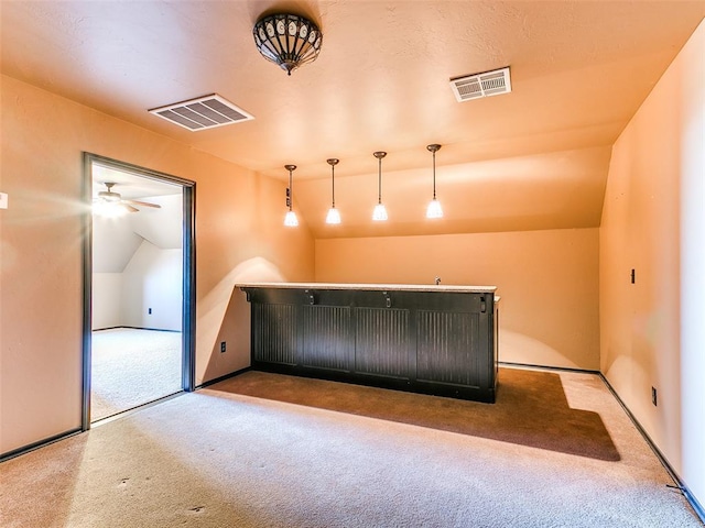 interior space with ceiling fan, light colored carpet, and vaulted ceiling