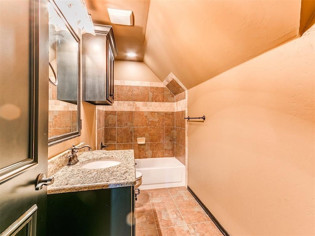 bathroom featuring a tub to relax in, vanity, vaulted ceiling, and toilet