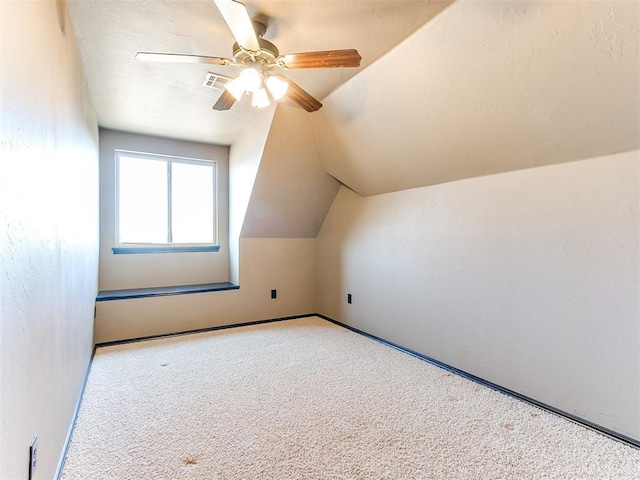 additional living space featuring light carpet, vaulted ceiling, and ceiling fan