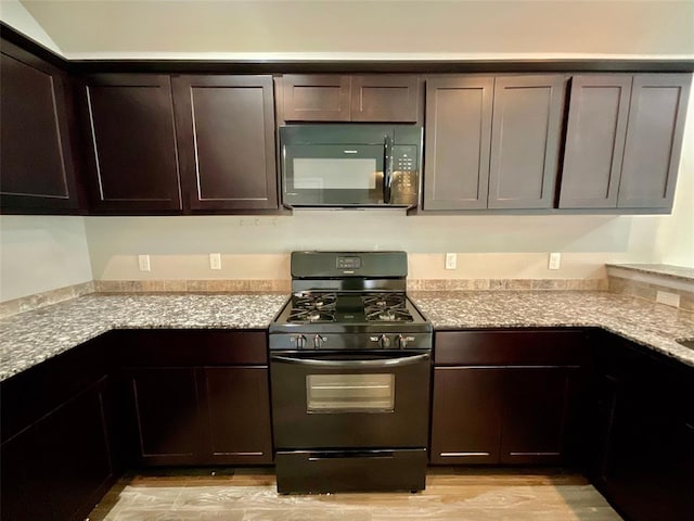 kitchen with black appliances, dark brown cabinets, and light stone countertops