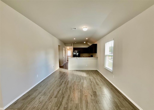 unfurnished living room featuring dark hardwood / wood-style flooring