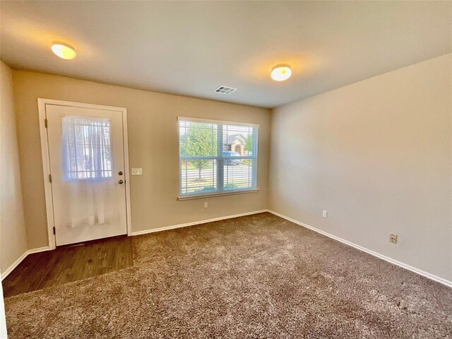 view of carpeted foyer entrance