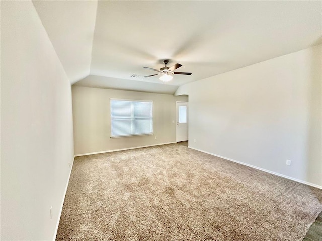 unfurnished room with ceiling fan, carpet, and vaulted ceiling