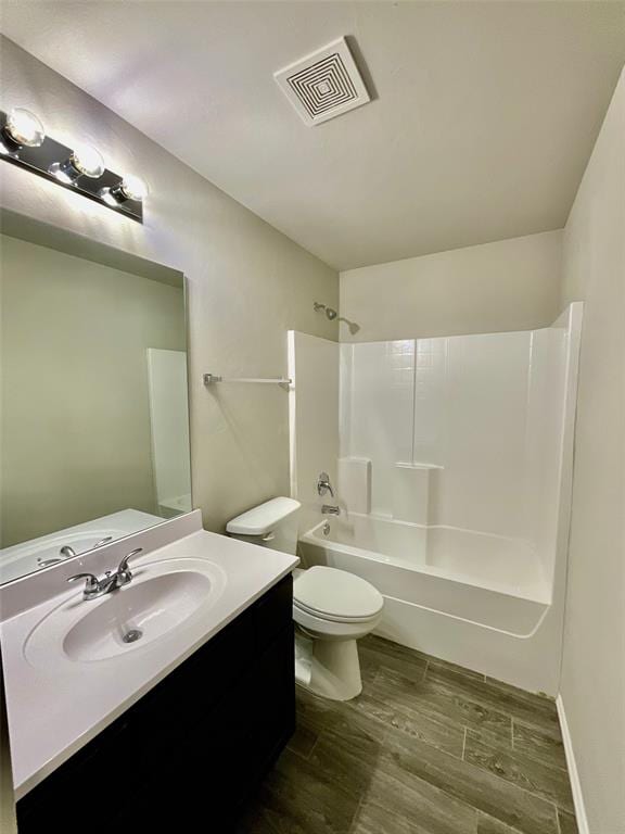 full bathroom with toilet, vanity, tub / shower combination, and hardwood / wood-style flooring