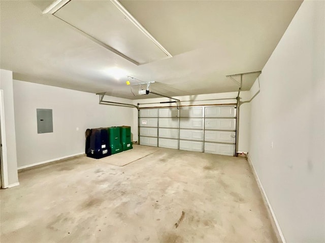 garage with a garage door opener and electric panel