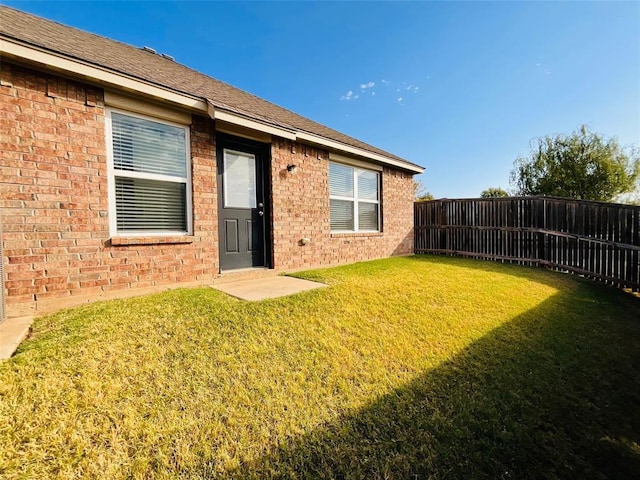 doorway to property featuring a lawn