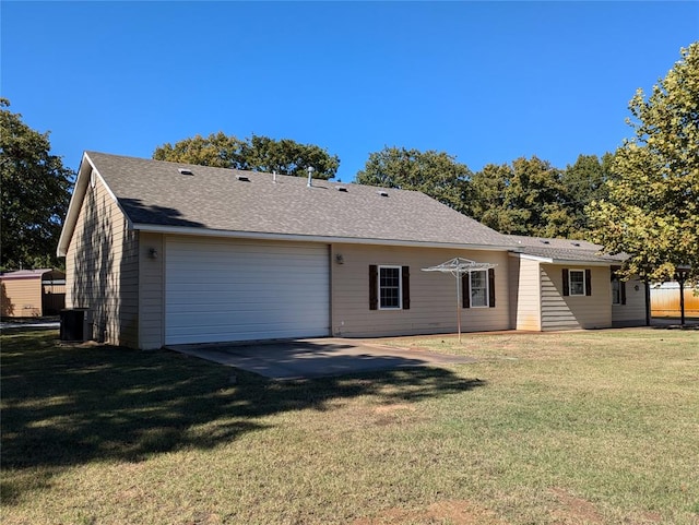 back of house featuring a lawn and central AC