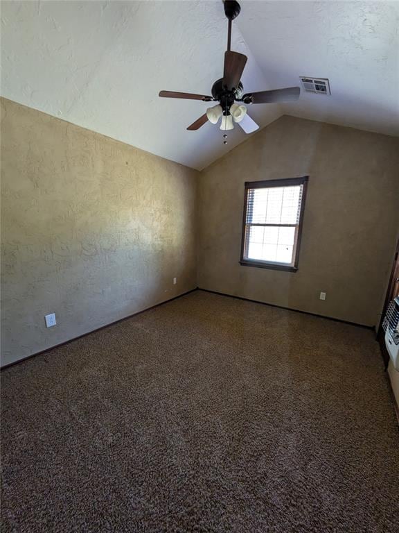 unfurnished room with ceiling fan, lofted ceiling, and a textured ceiling