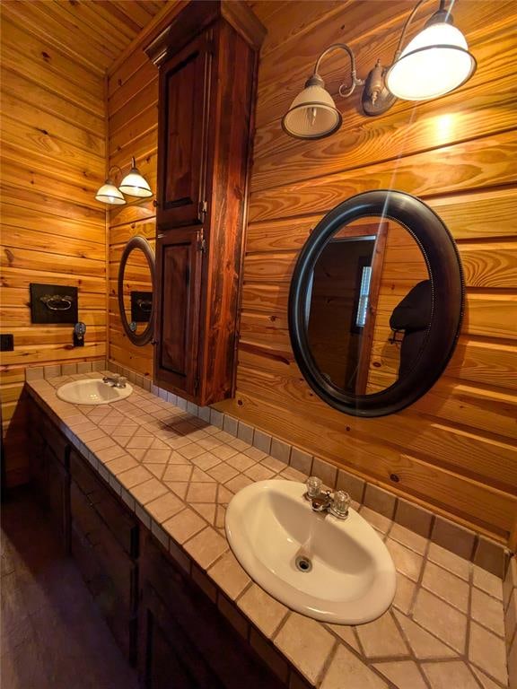 bathroom featuring vanity and wooden walls