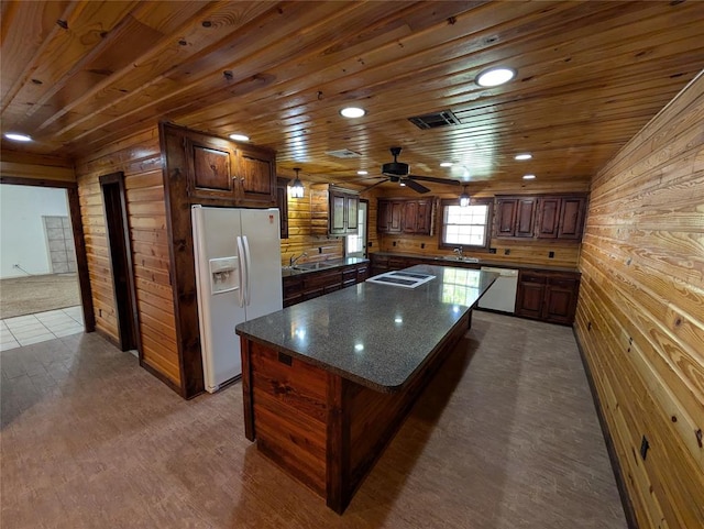 kitchen with wood ceiling, a kitchen island, white appliances, and wooden walls