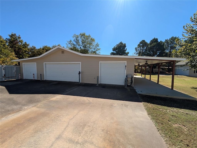 garage with ceiling fan and a yard