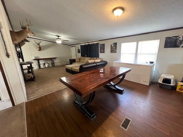 office area featuring ceiling fan, dark hardwood / wood-style floors, and a textured ceiling