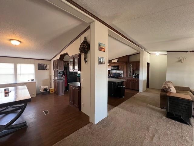 hallway featuring a textured ceiling, dark wood-type flooring, and vaulted ceiling