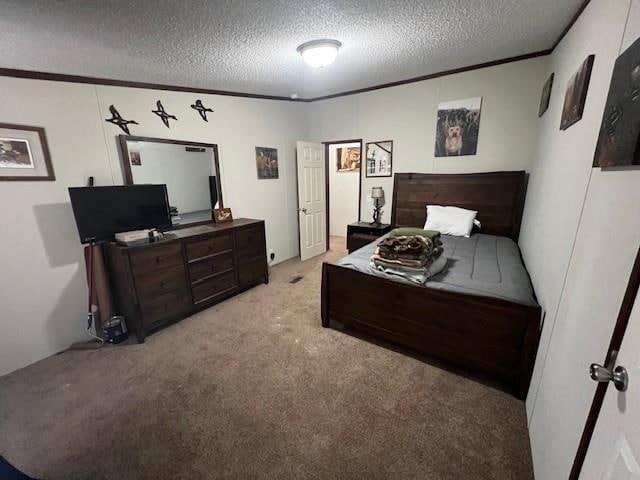 bedroom featuring light colored carpet, ornamental molding, and a textured ceiling