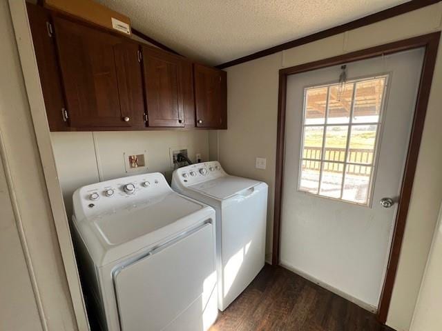 laundry room featuring cabinets, dark wood-type flooring, washing machine and dryer, a textured ceiling, and ornamental molding