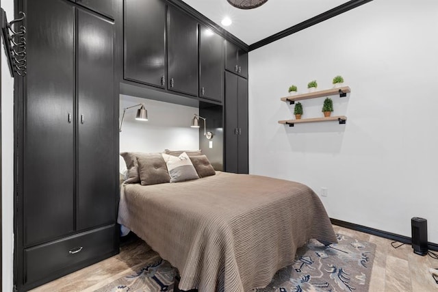 bedroom featuring light wood-type flooring and crown molding