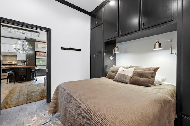 bedroom with an inviting chandelier and ornamental molding