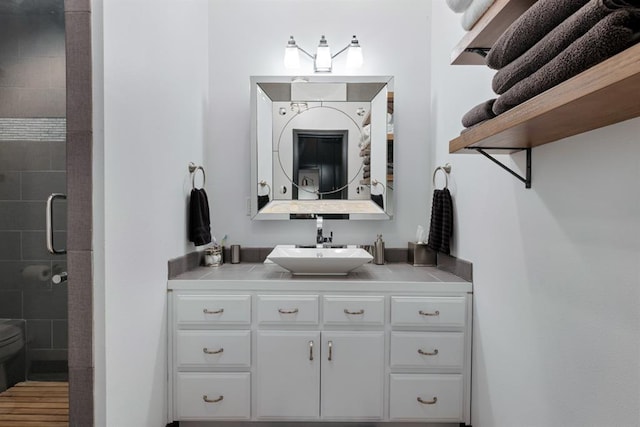 bathroom with hardwood / wood-style floors, vanity, toilet, and an enclosed shower