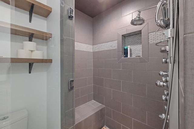 bathroom with toilet and a shower with shower door