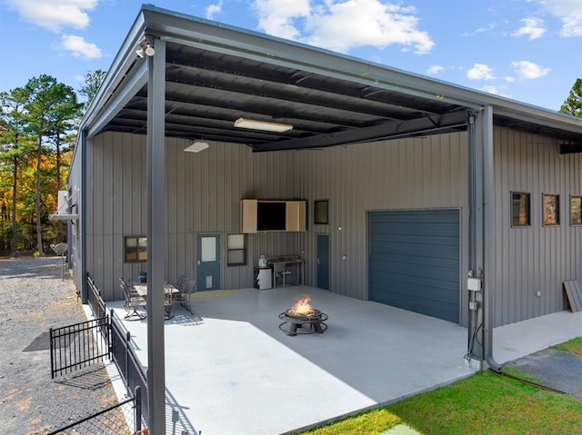 exterior space with a fire pit and a garage